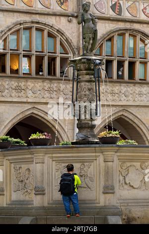 Historischer Marktplatz mit Rolandbrunnen vor dem Rathaus und einer kleinen Person, Hildesheim, Niedersachsen, Deutschland Stockfoto