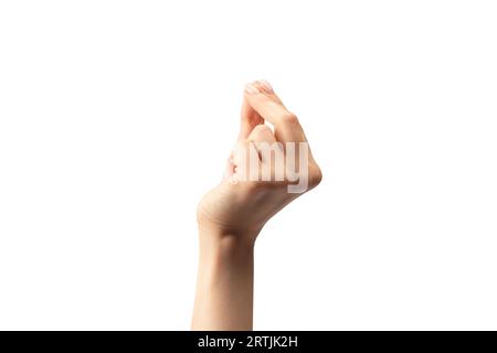 Die Hand einer Frau hält ein winziges oder dünnes Objekt, isoliert auf einem weißen Hintergrund. Stockfoto