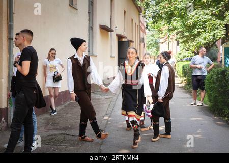 Bild eines jungen Mannes und einer jungen Frau, glücklich, ein serbisches kolo zu Proben und zu tanzen, sich auf eine Show in Erdevik vorzubereiten. Kolo ist ein Südslawier Stockfoto