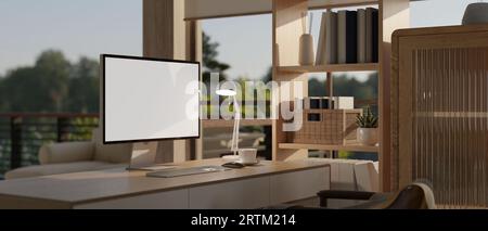 Ein Computertisch mit einem Computermodell mit weißem Bildschirm in einem modernen, modernen Home Office. Arbeitsplatzkonzept zu Hause. 3D-Rendering, 3D-Abbildung Stockfoto