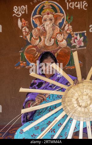 Adivasi-Frau, die Körbe in einem Dorf im Bezirk Narmada, Gujarat, Indien, herstellt Stockfoto