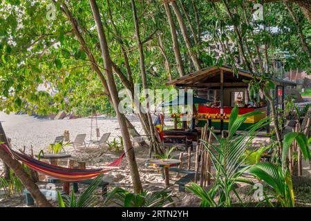 Bunte Bar mit Hängematten und Liegestühlen am Strand auf La Digue Island, Seychellen Stockfoto