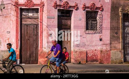 Camagüey, Kuba auf 3. Januar 2016: kubanische Männer auf Fahrrädern durch eine Straße in der Karibik Altstadt Zentrum von Camagüey Stockfoto