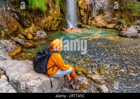 Tourist mit Rucksack am Grunas Wasserfall im Theth Nationalpark, Albanien. Albanische alpen Stockfoto