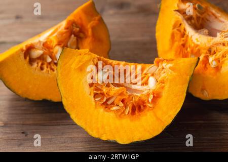 Drei Kürbisscheiben auf einem Holztisch Stockfoto