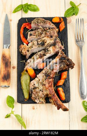 Geschnittenes Schweinekotelett Tomahawk. Gebratenes Tomahawk-Schweinefleischsteak. BBQ. Rustikaler Stil. Stockfoto