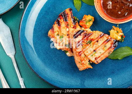 Gegrilltes Thunfischsteak mit Sauce auf einem Teller. Stockfoto