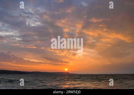 Weymouth, Dorset, Großbritannien. September 2023. Wetter in Großbritannien. Die Wolken leuchten orange bei Sonnenaufgang über der Jurassic Coast nach einer Nacht voller Gewitter in Weymouth in Dorset. Bildnachweis: Graham Hunt/Alamy Live News Stockfoto