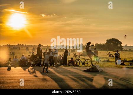 Tempelhofer Feld, Menschen bei Freizeitaktivitäten auf der Startbahn und Landebahn auf dem ehemaligen Flughafen Berlin-Tempelhof, Sonnenuntergang, BE Stockfoto