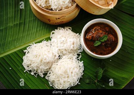 Idiyappam mit Hühnercurry | Kerala gedämpftes Frühstück aus Reismehl Stockfoto