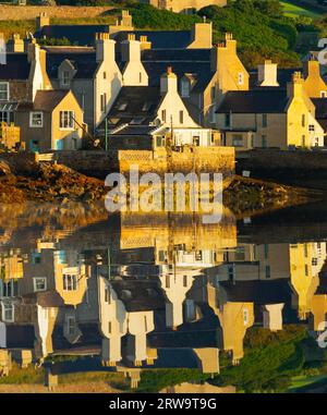 Am frühen Morgen Blick auf die Häuser in Stromness, die sich im Hafenwasser in Orkney Islands, Schottland, Großbritannien widerspiegeln Stockfoto