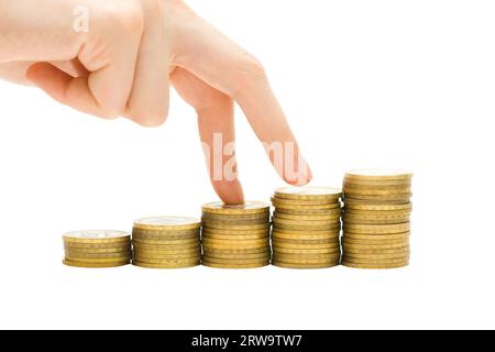 Wirtschaftswachstumskonzept, Gewinn steigt. Hand und Münzen isoliert auf weiß Stockfoto