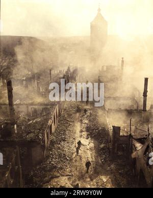 Infanteristen des 255. Infanterieregiments ziehen eine Straße in Waldenburg hinunter, um die Hunnen nach einem kürzlichen Überfall der 63. Division zu jagen. April 1945. Stockfoto