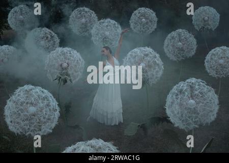 Wunderschöne Ballerina mit riesigen Löwenzahn-Blüten Stockfoto