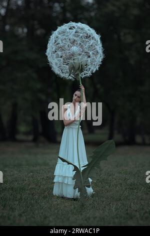 Wunderschöne Ballerina mit riesigen Löwenzahn-Blüten Stockfoto