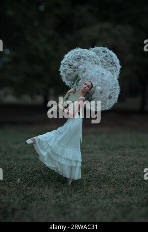 Wunderschöne Ballerina mit riesigen Löwenzahn-Blüten Stockfoto