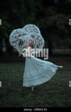 Wunderschöne Ballerina mit riesigen Löwenzahn-Blüten Stockfoto