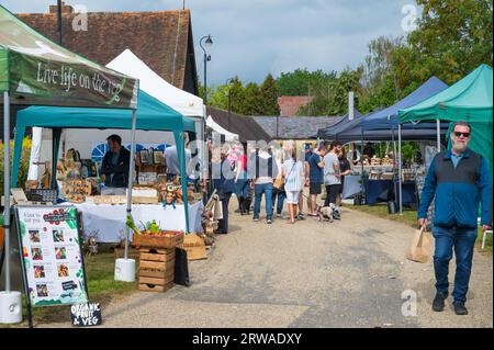 Besucher besuchen die Verkaufsstände am Duckpond Market, einem traditionellen Lebensmittel- und Kunsthandwerksmarkt, der monatlich auf der Manor Farm in Ruislip, Middlesex, England, Großbritannien stattfindet Stockfoto