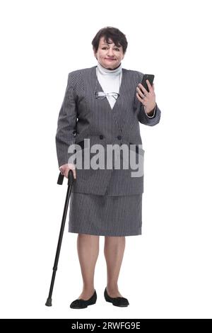 In vollem Wachstum. Casual ältere Frau mit einem Mobiltelefon. Stockfoto