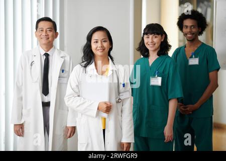 Team von lächelnden Ärzten und medizinischen Krankenschwestern, die im Krankenhaus stehen Stockfoto
