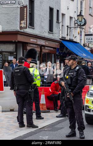 Windsor, Großbritannien. September 2023. Polizeibeamte neigen während des Wachwechsels in der Windsor High Street zu einem verletzten Grenadier-Wachmann. Laut einem Zeremonialbeamten, der am Tatort anwesend war, rutschte der Wachmann aus und Schnitt sich auf, während er nach Windsor Castle marschierte. Quelle: Mark Kerrison/Alamy Live News Stockfoto