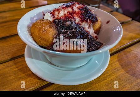 Papanasi: Ein traditionelles rumänisches Dessert. Hergestellt aus Donuts, die mit Sauerrahm und Obstmarmelade bedeckt sind Stockfoto