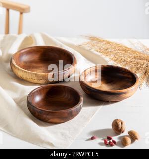 Handgefertigte Holzschalen auf weißem Tisch Stockfoto