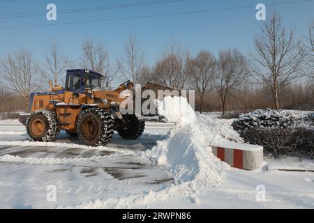 LUANNAN COUNTY, China - 14. Februar 2022: highway Traffic Manager fahren Gabelstapler, um den Schnee auf der Autobahn zu räumen und sicherzustellen, dass die Autobahn frei ist Stockfoto