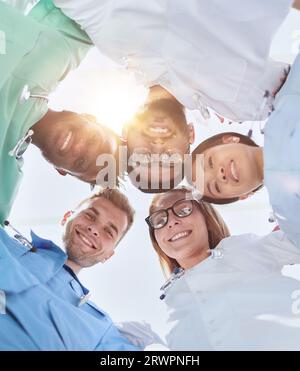 GRUPPE MULTINATIONALER PRAKTIKANTEN, DIE LÄCHELND HINUNTERSCHAUEN Stockfoto