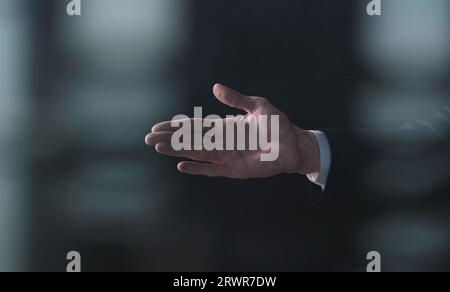 Die Hand eines Mannes bettelt um etwas isoliertes auf schwarzem Hintergrund. Handfläche hoch, Nahaufnahme. Stockfoto