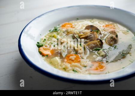 Nudelsuppe mit Venusmuscheln und Karotten und anderem Gemüse der Saison. Stockfoto