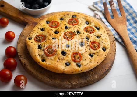 Italienische Foccaccia mit schwarzen Oliven und Kirschtomaten. Stockfoto