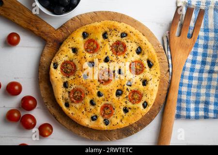Italienische Foccaccia mit schwarzen Oliven und Kirschtomaten. Stockfoto