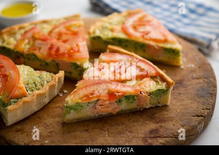 Quiche im französischen Stil mit Brokkoli, Lachs und Tomatenscheiben. Stockfoto