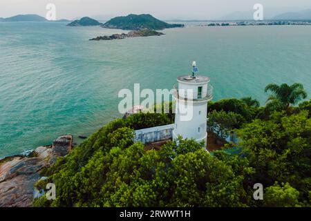 Blick aus der Vogelperspektive auf die malerische Küste mit Leuchtturm in Santa Catarina, Brasilien Stockfoto