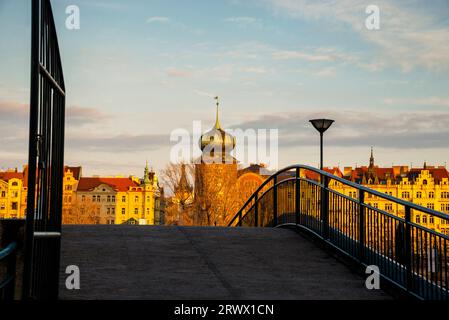 Zwiebelgewölbe aus dem 15. Jahrhundert Šítkov Wasserturm hinter einer kleinen Fußgängerbrücke über die Moldau in Prag, Tschechien. Stockfoto