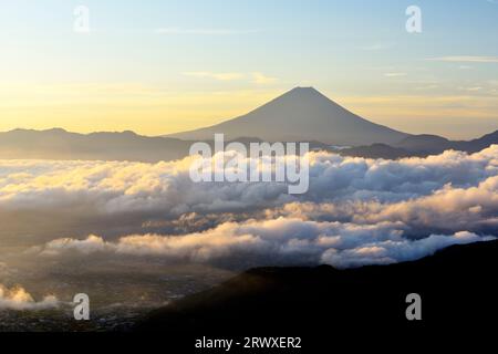 Fuji in a sea of clouds bathed in morning sun Stock Photo