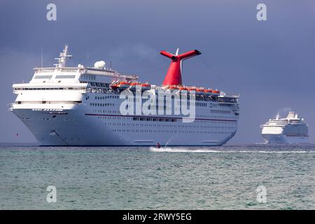 Der Blick am Morgen auf zwei Kreuzfahrtschiffe, die zur Insel Grand Cayman (Cayman Islands) ankommen. Stockfoto