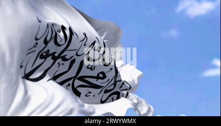 Flagge des Islamischen Emirats Afghanistan winkt an einem klaren Tag im Wind. 3D-Illustrations-Rendering. Selektiver Fokus. Geriffeltes Material Stockfoto