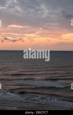 Sonnenuntergang Meer Strand schäumende Wellen Stockfoto