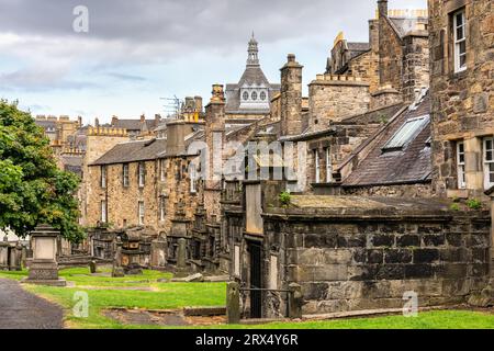 Sehr alte Gräber neben Wohnhäusern auf dem Greyfriars Cemetery in Edinburgh, Schottland. Stockfoto