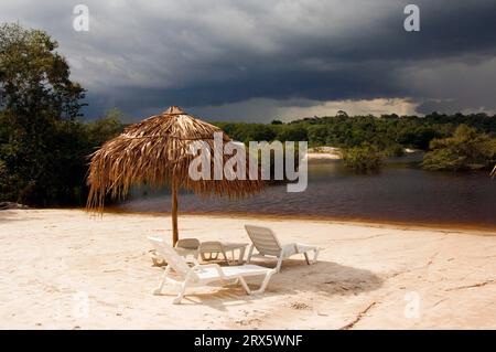 Sonnenschirm und Liegestühle am Strand, Amazon Eco Lodge, Rio Taruma, Manaus, Amazonas State, Brasilien Stockfoto