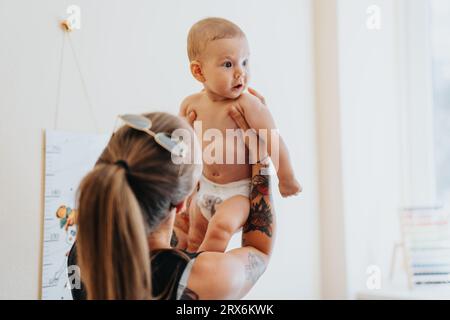 Familienbesuch in der Kinderarztpraxis für Baby-Check-up und -Diagnose Stockfoto