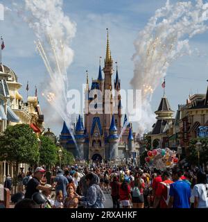 Orlando, USA - 25. Juli 2023: Eine Menge Besucher im Disney World Magic Kingdom, zur Zeit eines Feuerwerks über dem Cinderella Castle. Stockfoto