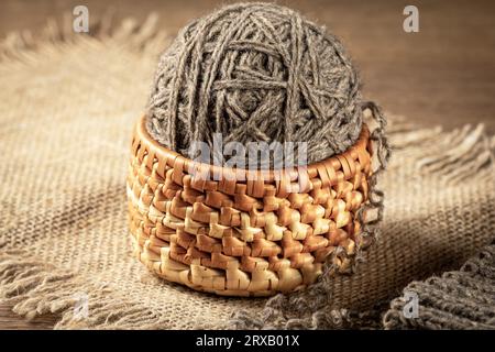 Eine Kugel selbstgemachtes Garn in einem Korb aus der Nähe Stockfoto