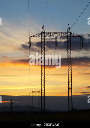 Electricity pylon on sunset - power energy Stockfoto