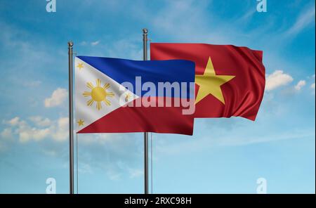 Die Flagge Vietnams und der Philippinen winkt im Wind am blauen Himmel zusammen Stockfoto