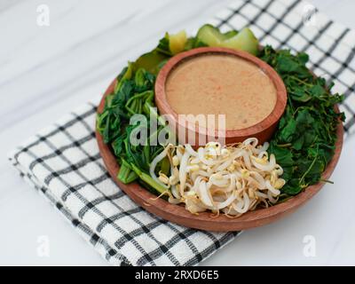 Pecel Sayur oder gemischtes gedämpftes Gemüse mit Erdnusssoße. Traditionelle Speisen aus Zentral-Java oder Ost-Java, Indonesien Stockfoto