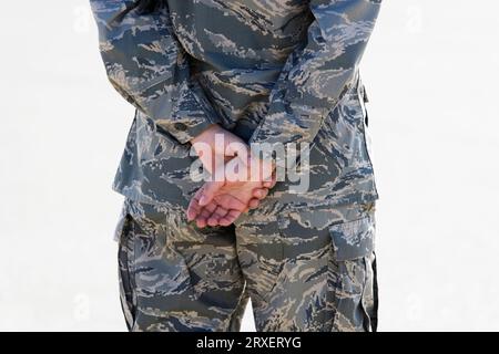 Nahaufnahme, Rückansicht der Person in einer Militäruniform mit hinter dem Rücken verschnallten Händen. Stockfoto