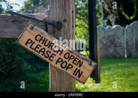 „Kirche offen, bitte kommen Sie herein“-Schild an einem Kirchentor. Stockfoto